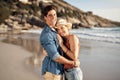 Couple hug, portrait and sunshine by ocean for smile, holiday romance, love together and honeymoon. Happy woman, face
