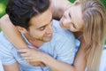 Couple, hug and relax in park with smile, love and commitment in healthy relationship. People on a date outdoor