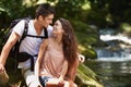 Couple, hug and vacation for hiking in jungle with smile for thinking, holiday and connection by river. Man, woman and Royalty Free Stock Photo