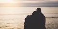 Couple hugging on background beach ocean sunrise, meeting of lovers concept, silhouette two romantic people cuddling and looking Royalty Free Stock Photo