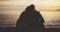 Couple hugging on background beach ocean sunrise, silhouette two romantic people cuddling and looking on rear view evening sea