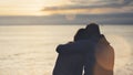 Couple hugging on the beach on background ocean sunrise, silhouette two romantic people cuddling and looking on rear view evening Royalty Free Stock Photo