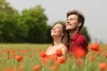 Couple hugging and breathing fresh air in a red field Royalty Free Stock Photo