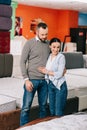 couple hugging while choosing mattress together