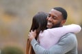 Couple hugging and happy man smiling in a park Royalty Free Stock Photo