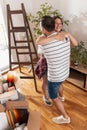 Couple hugging and holding apartment keys while moving in together