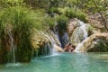 Couple hugging and kissing under waterfall Royalty Free Stock Photo