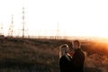 Couple hugging on Power lines background on sunset. Save the planet and electricity. Humanity and electricity. Energy Royalty Free Stock Photo