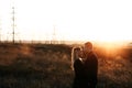 Couple hugging on Power lines background on sunset. Save the planet and electricity. Humanity and electricity. Energy Royalty Free Stock Photo