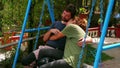 Couple hugging on swing