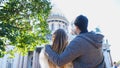 Couple hugs and looks at Cathedral. Concept. Beautiful couple on vacation looking at historical sights of city. Back Royalty Free Stock Photo