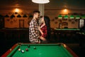 Couple hugs at the table in billiard room Royalty Free Stock Photo