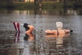 Couple ice bathing in the cold water of a lake in Preili, Latvia on the independence day