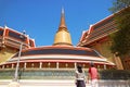 Couple Impressed by a 43 Meters High Gilded Pagoda and the Iconic Circular Gallery of Wat Ratchabophit Buddhist Temple, Bangkok