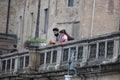Couple with Indian features Resting on the Railing of the Bridge in the center of Parma on a Spring Day, Italy