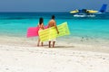 Couple with inflatable rafts looking at seaplane on beach