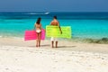 Couple with inflatable rafts on a tropical beach