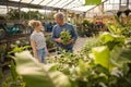 Couple Inside Greenhouse In Garden Centre Choosing And Buying Plants Royalty Free Stock Photo