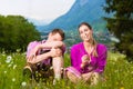 Couple with issues in Alpine meadow Royalty Free Stock Photo