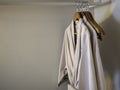 Couple of Japanese style cotton bathrobes hanging on the wooden hangers on the rack. Royalty Free Stock Photo