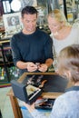 Couple in jewelers shop man holding wristwatch