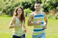 Couple of joggers doing running at park and smiling Royalty Free Stock Photo