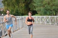Couple of joggers running on the bridge
