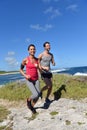 Couple of joggers running on the seaside