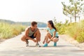 Couple of joggers tying sneakers shoelaces