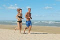 Couple jogging on beach Royalty Free Stock Photo