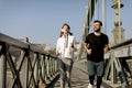 Couple jogging on Chain Bridge in Budapest Royalty Free Stock Photo