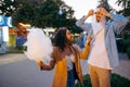 Couple jokes with cotton candy in amusement park