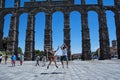 Couple jumping happily in front of roman ruins