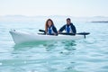 Couple, kayak and rowing boat on lake, ocean or river for water sports and fitness challenge. Portrait of man and woman