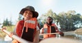 Couple, kayak and rowing on a lake in nature for sports challenge, adventure or travel with a smile. Young man and woman