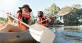 Couple, kayak and rowing on a lake in nature for sports challenge, adventure or travel with a smile. Young man and woman Royalty Free Stock Photo