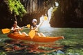 Couple of kayakers swims under the cliff in sea Royalty Free Stock Photo