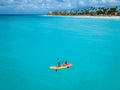 Couple Kayaking in the Ocean on Vacation Aruba Caribbean sea, man and woman mid age kayak in ocean blue clrea water