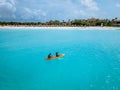 Couple Kayaking in the Ocean on Vacation Aruba Caribbean sea, man and woman mid age kayak in ocean blue clrea water