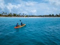 Couple Kayaking in the Ocean on Vacation Aruba Caribbean sea, man and woman mid age kayak in ocean blue clrea water