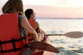 Couple kayaking together. Beautiful young couple kayaking on sea together and smiling Royalty Free Stock Photo