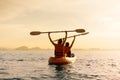 Couple kayaking together. Beautiful young couple kayaking on lake together and smiling at sunset Royalty Free Stock Photo