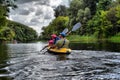 Couple kayaking together in river. Tourists kayakers touring the river Royalty Free Stock Photo