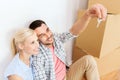 Couple with key and boxes moving to new home Royalty Free Stock Photo