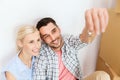 Couple with key and boxes moving to new home Royalty Free Stock Photo