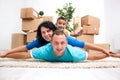 Couple with a kid in their new home laying on the floor with car Royalty Free Stock Photo