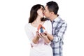 Couple kising while holding a model house Royalty Free Stock Photo