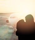 Couple kiss on the background of plane. The concept of meeting or parting two people Royalty Free Stock Photo