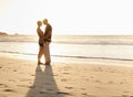 Couple, kiss and beach at sunset for romantic date, weekend getaway and vacation in Mexico. Woman, man or people in love Royalty Free Stock Photo