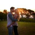 Couple kiss, nature and trees in sunset with love, romance and date on adventure, travel or honeymoon. Man, woman and Royalty Free Stock Photo